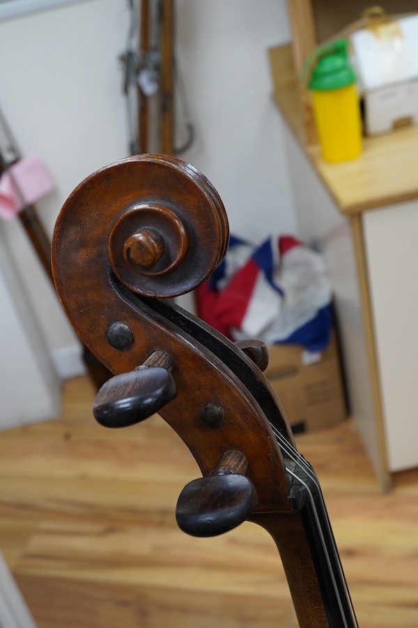 A cased late 19th century German? cello, body length 75cm, together with two bows. Condition - fair to good.